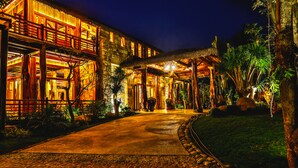 A well-lit, multi-story building with a covered walkway and lush greenery. - Ocean Bay Resort & Spa Phu Quoc (Phu Quoc)