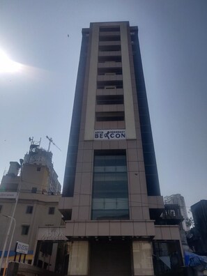 A tall building with a sign reading 'ADIVA RESIDENCY BEACON.' - Adiva Residency Beacon,mumbai (Mumbai)