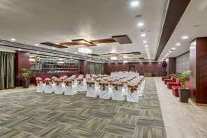A conference room with rows of chairs, a chandelier, and a carpeted floor. - The Fern Residency Asansol (Asansol)