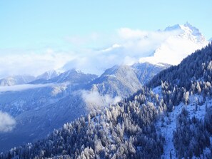 A mountainous landscape with snow-covered trees and a peak in the distance. - Maiensäss Stafel 45, (Mutten), by Interhome (Thusis)