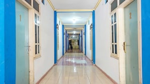 A corridor with doors numbered 1 and 2, leading to rooms. - Oyo 91766 Fortuna Hotel Syariah (Banyumas)