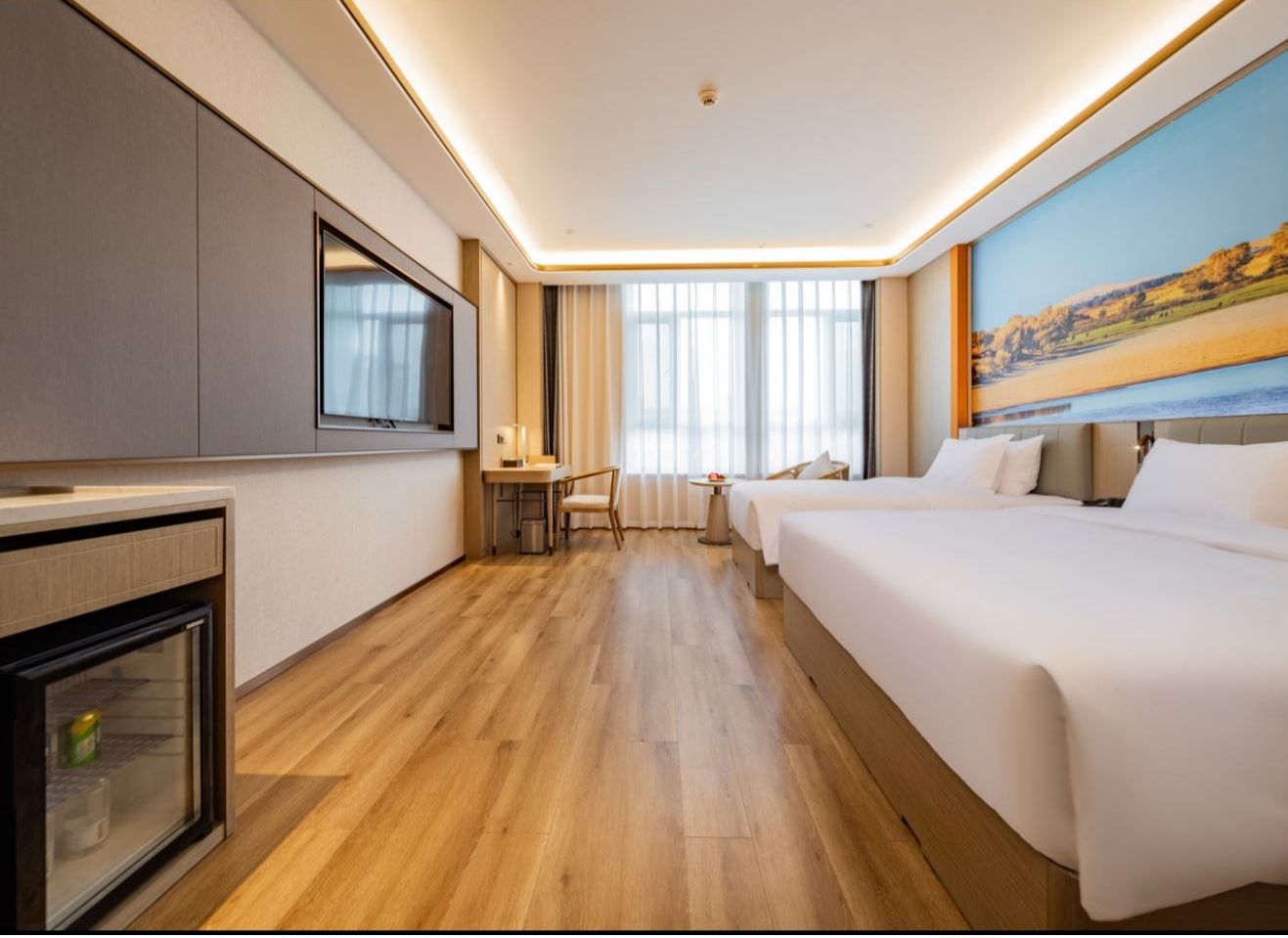 A hotel room with a bed, a desk, a television, and a window with a view.