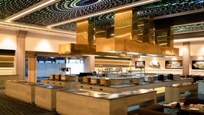 A modern kitchen with a central island, stainless steel appliances, and a patterned ceiling. - Aureum Grand Hotels & Resorts (Pathankot)