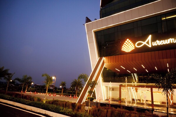 A modern building with a prominent illuminated sign reading 'Aureum.'