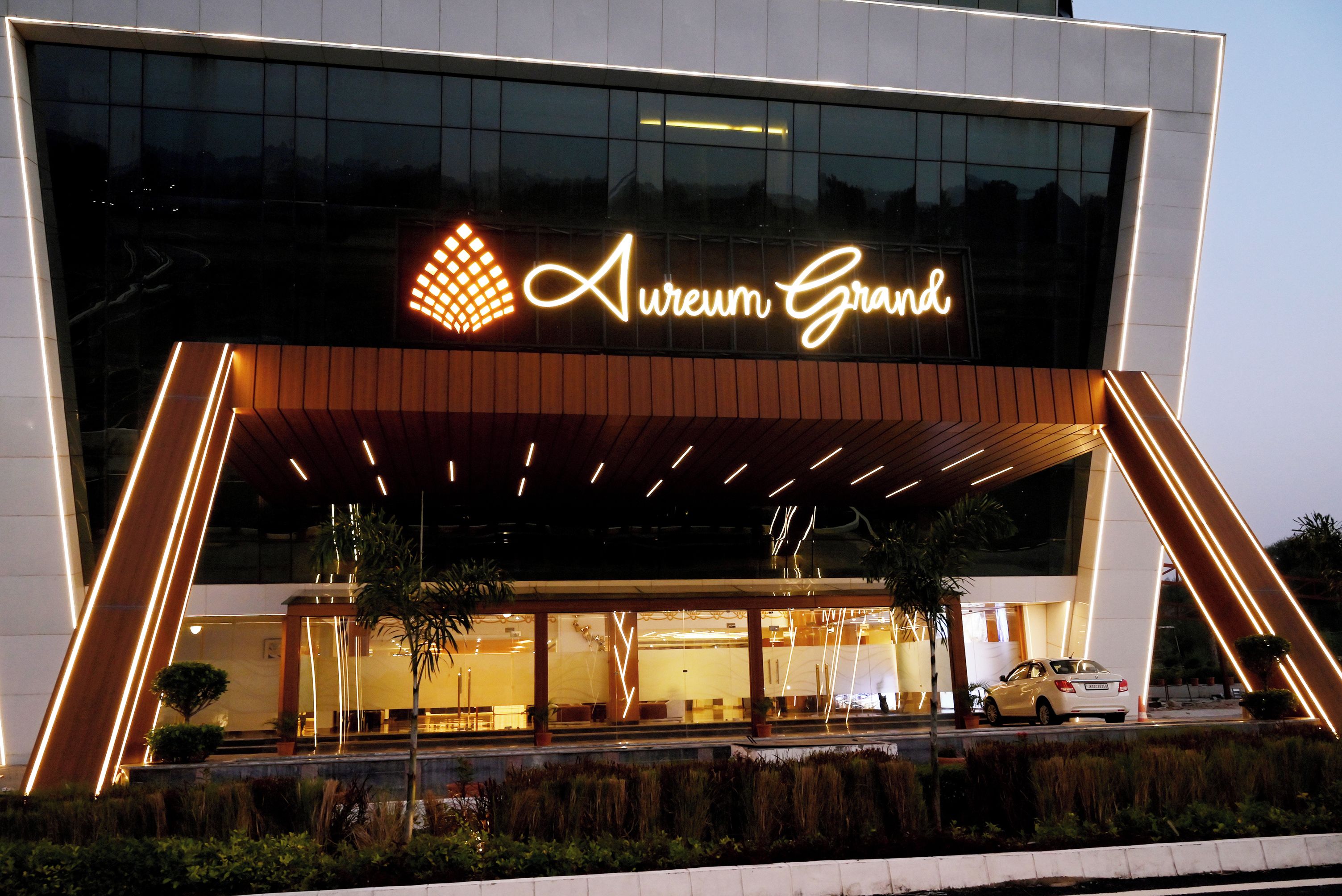 A modern building with a prominent sign reading 'Aureum Grand.'