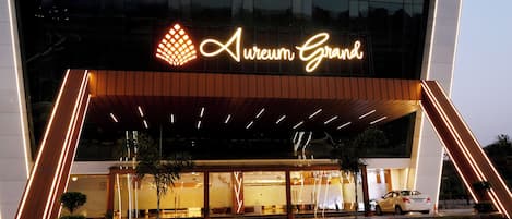 A modern building with a prominent sign reading 'Aureum Grand.'
