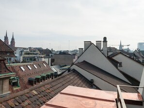 Un paisaje urbano que muestra una mezcla de arquitectura histórica y moderna, incluyendo una iglesia destacada con dos torres y una variedad de estilos de construcción.