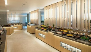 A modern buffet setup with multiple food stations and a clean, contemporary design. - Senseana Seaside Resort And Aquadventure (Analipsis)
