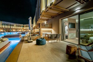 A rooftop pool area with lounge seating and a dining area. - Senseana Seaside Resort And Aquadventure (Analipsis)