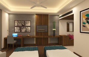 A modern hotel room with a wooden desk, a flat-screen TV, two beds, and artwork on the walls. - The Fern - An Ecotel Hotel, Alwar (Malakhera)