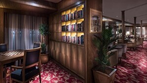 A library with bookshelves, a chess table, and a red carpeted floor. - Steigenberger Regency Cruise 4&7 Nights From Luxor (Luxor)