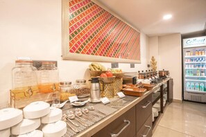 A breakfast bar with various food items, a fruit bowl, and a refrigerator labeled 'Cellfrost'. - Amritara Kirpa, Amritsar Golden Temple (Amritsar)