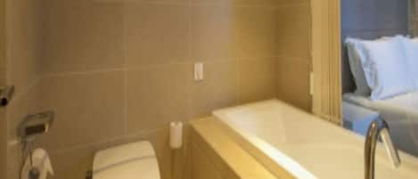 A bathroom with a toilet, a sink, and a bathtub.