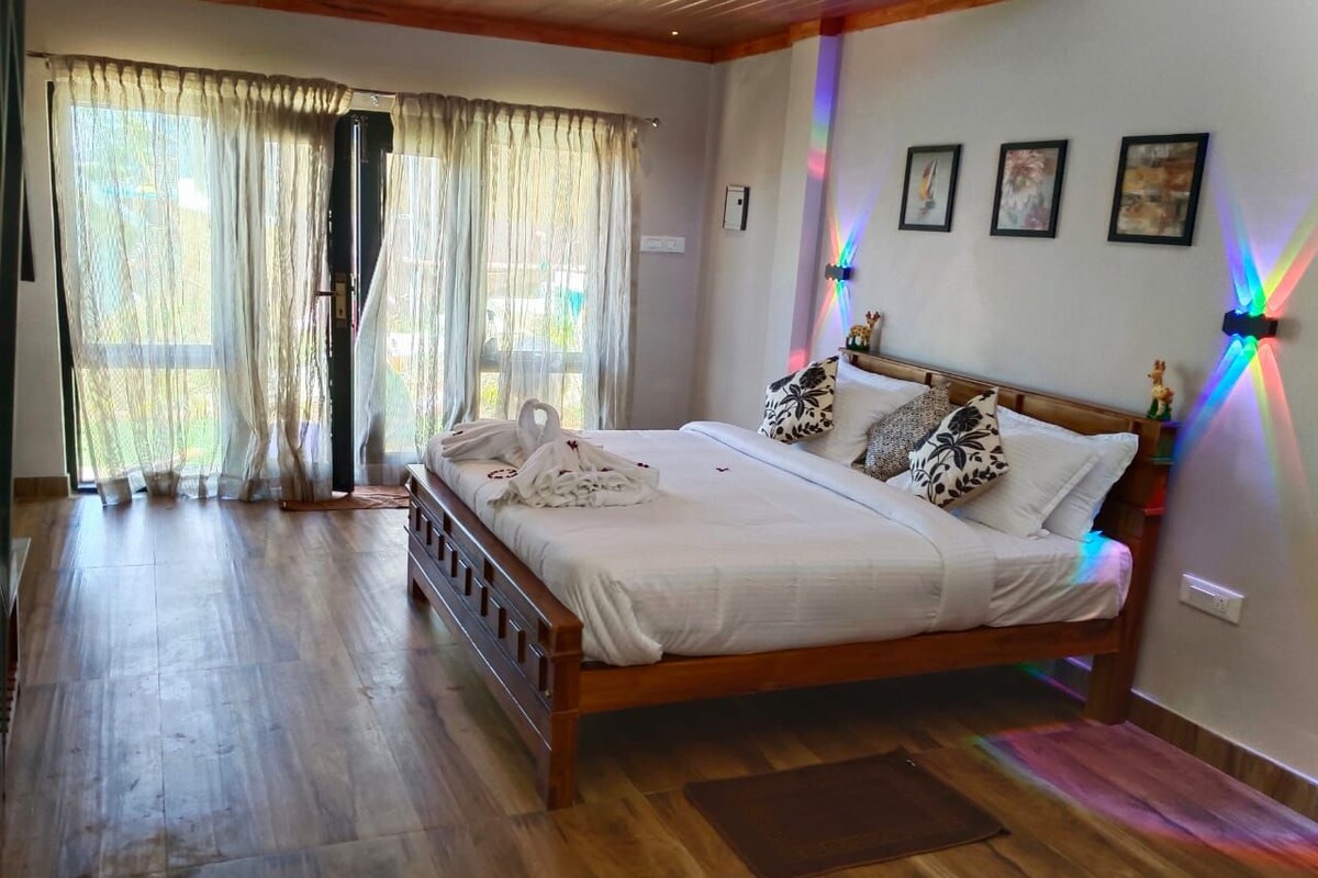 A bedroom with a wooden bed, curtains, and a wall-mounted light fixture.