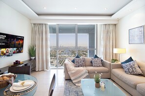 A modern living room with a sofa set, a glass coffee table, and a dining area with a table and chairs. - Songs Of The Lake By Lagom In Bonnington Tower (Dubai)