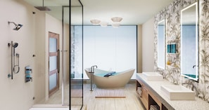 A modern bathroom with a freestanding bathtub, a glass-enclosed shower, and a vanity with a large mirror.