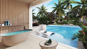 Un área de piscina moderna con una bañera grande, sillas de descanso y plantas tropicales.