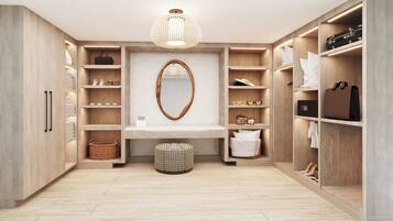 A modern, well-organized walk-in closet with wooden shelving, a mirror, and a hanging light fixture.