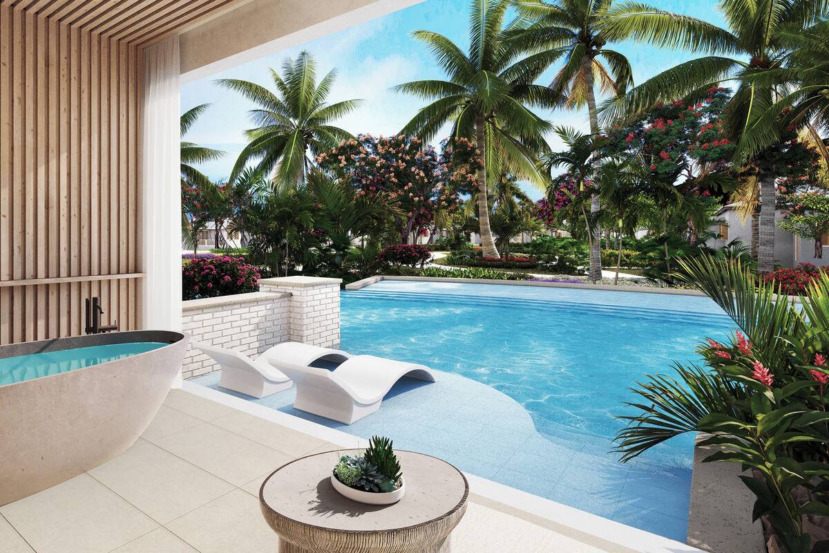 Uma área de piscina moderna com uma banheira grande, cadeiras de sol e plantas tropicais.