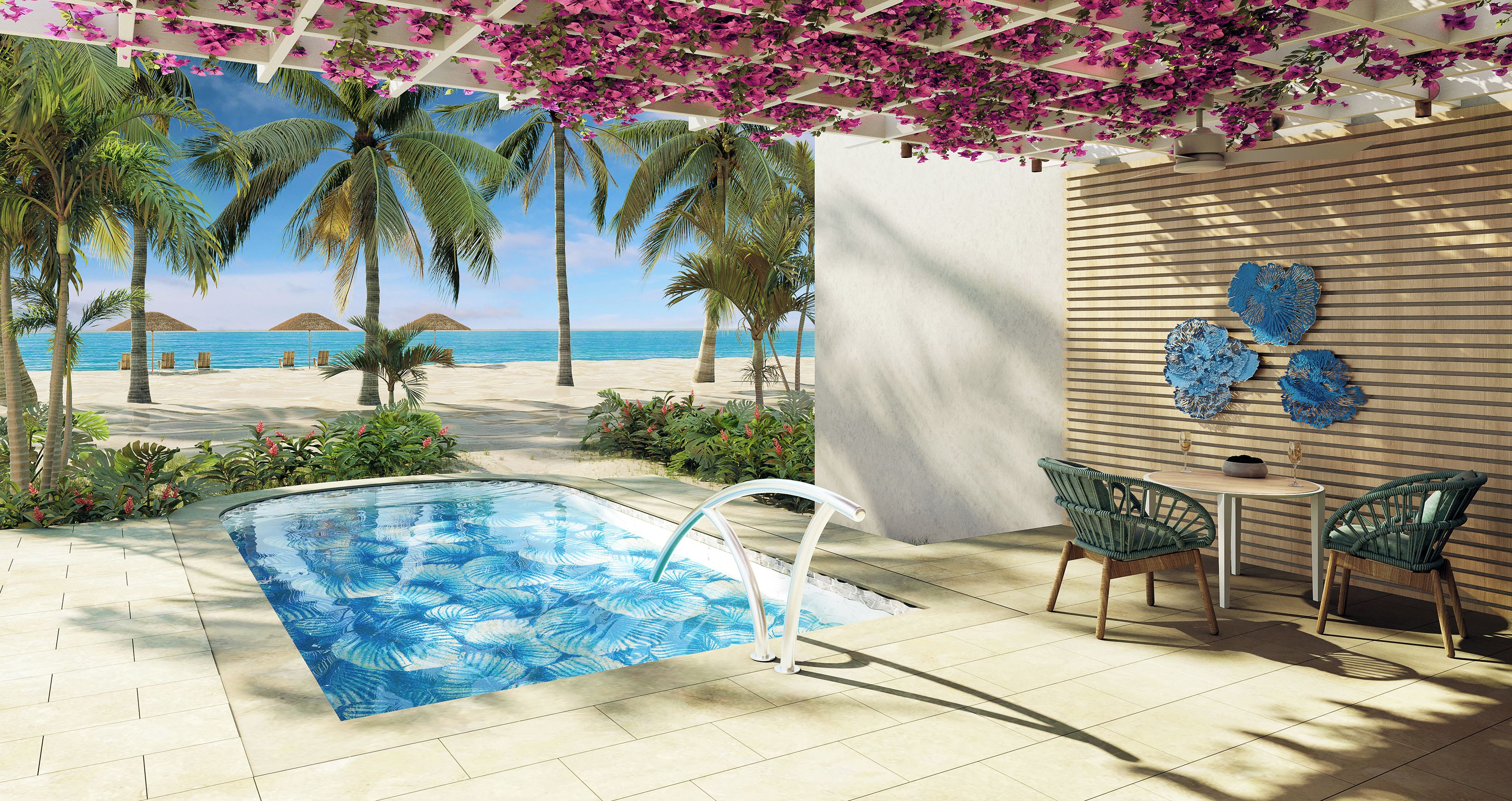 Un área de piscina con vista a la playa, sillones reclinables y una mesa con vasos.