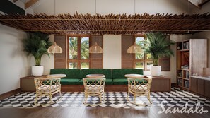 A room with a green sofa, two rocking chairs, a checkered floor, a wooden ceiling, and a bookshelf. - Sandals Saint Vincent And The Granadines (Kingstown)