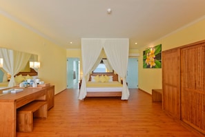 A bedroom with a wooden bed, a bedside table, a large mirror, and a wooden wardrobe. - Dreamland Maldives (Hirundhoo)