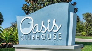 A sign for Oasis Clubhouse at ChampionsGate. - Champions Gate Resort Homes (Davenport)