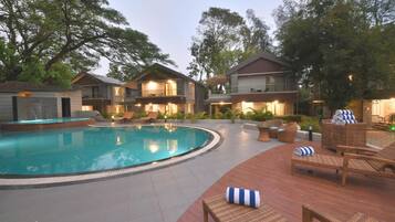 A pool area with lounge chairs and a swimming pool.