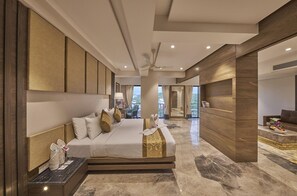A modern hotel room with a large bed, a desk, and a view of the outdoors. - Regenta Central Imperial Candolim (Candolim)