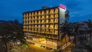 A multi-story hotel with balconies, a pool area, and a sign indicating it is a hotel. - Regenta Central Imperial Candolim (Candolim)