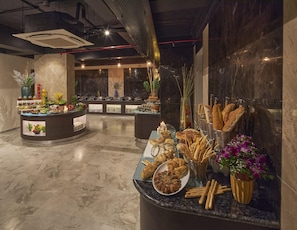 A buffet area with various food items and a marble floor. - Regenta Central Imperial Candolim (Candolim)