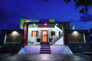 A building with a sign reading "SRI SAKTHI RESIDENCE" and a staircase leading to the entrance.