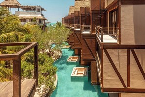 A resort with overwater bungalows, a swimming pool, and lush tropical vegetation. - Awa Holbox Hotel Boutique - Beach Front (Isla Holbox)