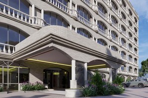 A multi-story hotel with a curved facade, balconies, and a covered entrance area. - Delta Hotels Marriott, Dar es Salaam (Dar es Salaam)