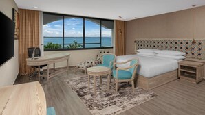 A hotel room with a large window, a bed, a desk, and two chairs. - Delta Hotels Marriott, Dar es Salaam (Dar es Salaam)