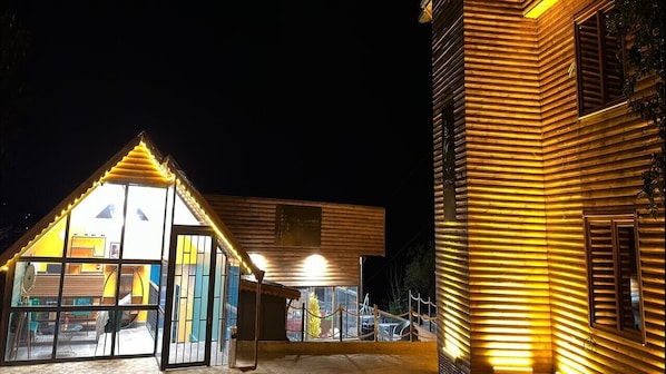 A building with a triangular entrance and a wooden facade.