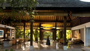 A spacious indoor area with a high ceiling, wooden beams, and a central circular table.