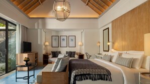 A modern bedroom with a large bed, bedside tables, a TV, and artwork on the wall.