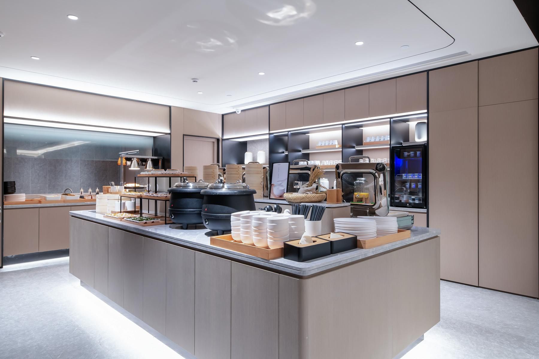 A modern, well-lit kitchen area with a central island, various food items, and kitchen appliances.