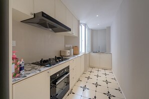 A modern kitchen with a stove, oven, and a range hood.