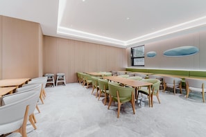 A modern conference room with a long table, chairs, and a large window.