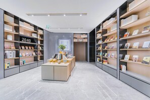 A modern bookstore with shelves on both sides, a central display table, and a sign reading '2040 BOOKSTORE'.