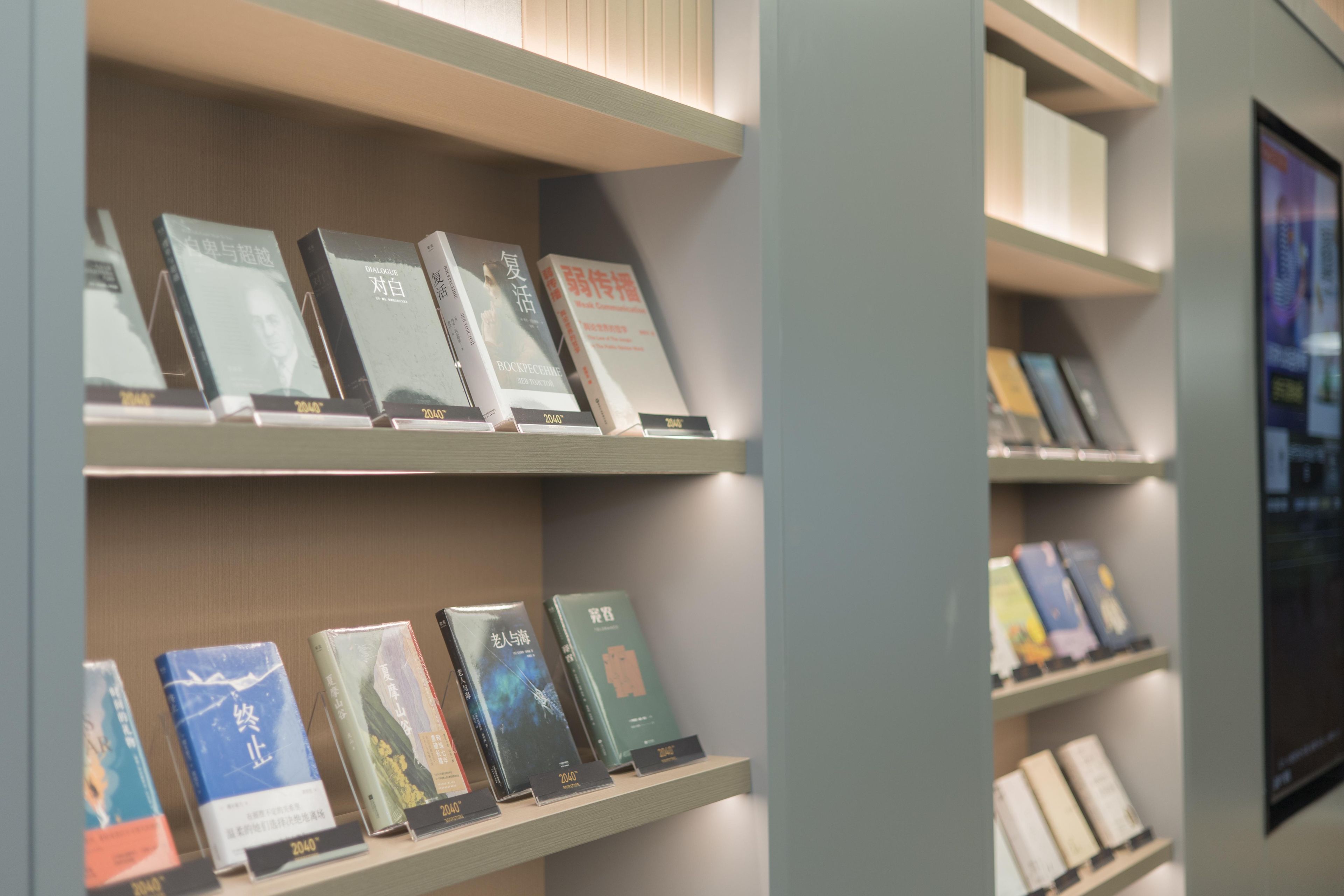A bookshelf with books, some with titles and others with images on the covers.