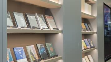 A bookshelf with books, some with titles and others with images on the covers.