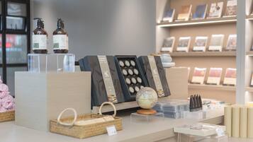 A display of various items including bottles, a globe, and boxes on a counter.