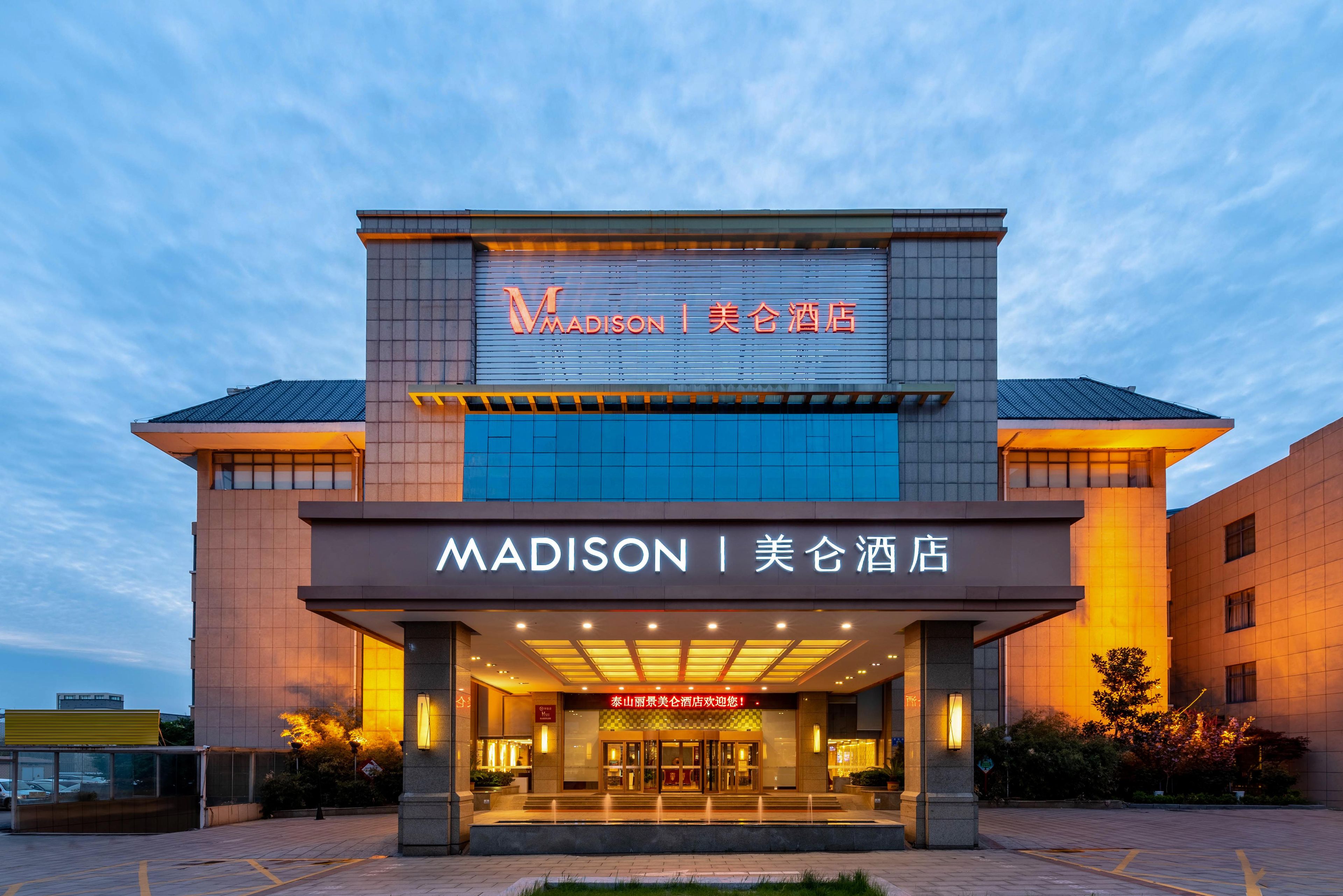 A hotel with a modern facade, illuminated signage, and a welcoming entrance.