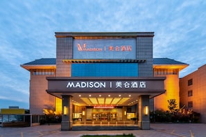 A hotel with a modern facade, illuminated signage, and a welcoming entrance. - Madison Hotel Tai Mountain Scenic Spot (Tai'an)