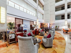 A spacious lobby with high ceilings, a bar area, and seating arrangements. - Madison Hotel Tai Mountain Scenic Spot (Tai'an)