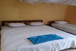 A hotel room with two beds, white bedding, and a blue towel on the larger bed. - OYO 91230 Kelimutu Eco Village (Moni)