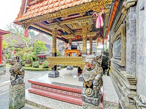 A traditional Balinese temple with ornate carvings and a central altar.